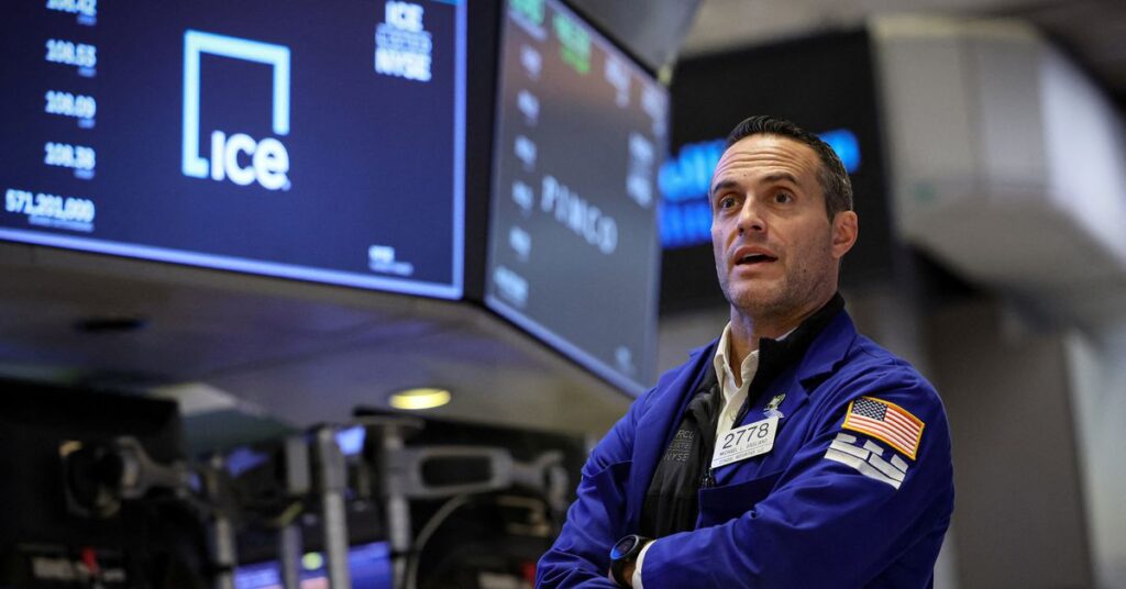 Traders work on the floor of the NYSE in New York