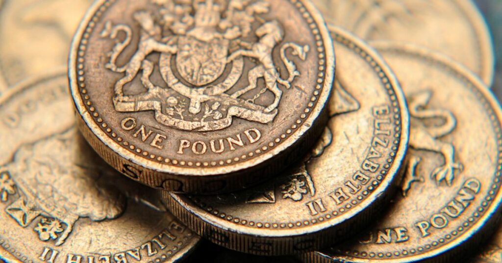 A pile of one pound coins is seen in a photo illustration