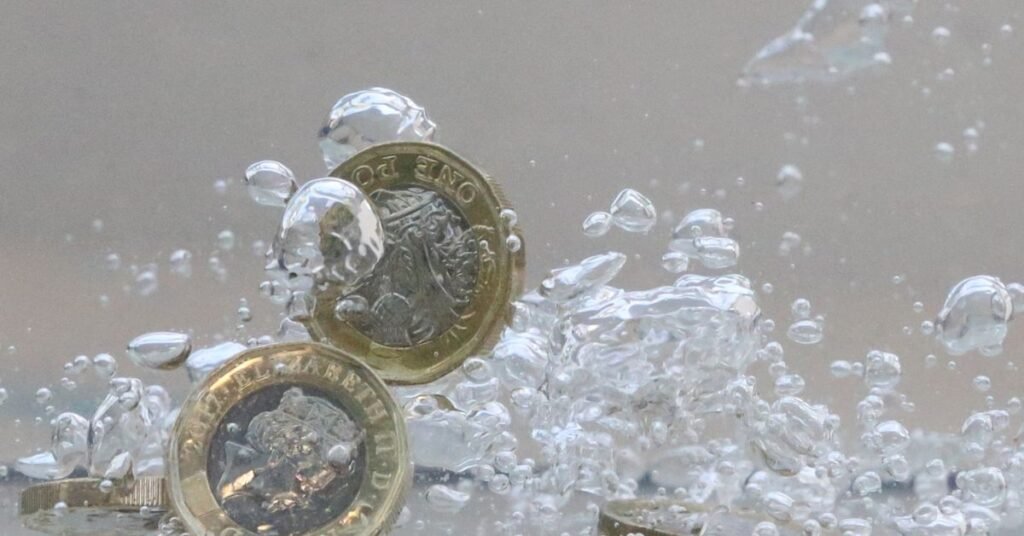 UK pound coins plunge into water in this illustration picture