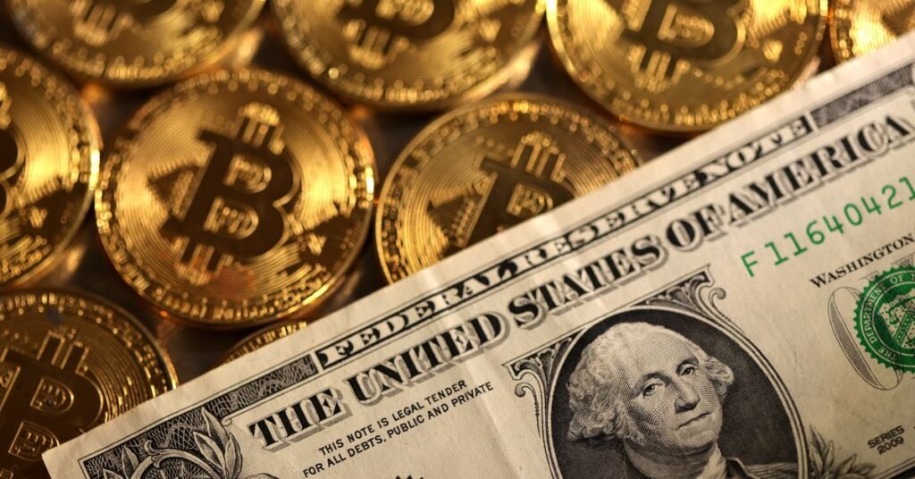 Illustration shows representations of cryptocurrency Bitcoin and U.S. dollar