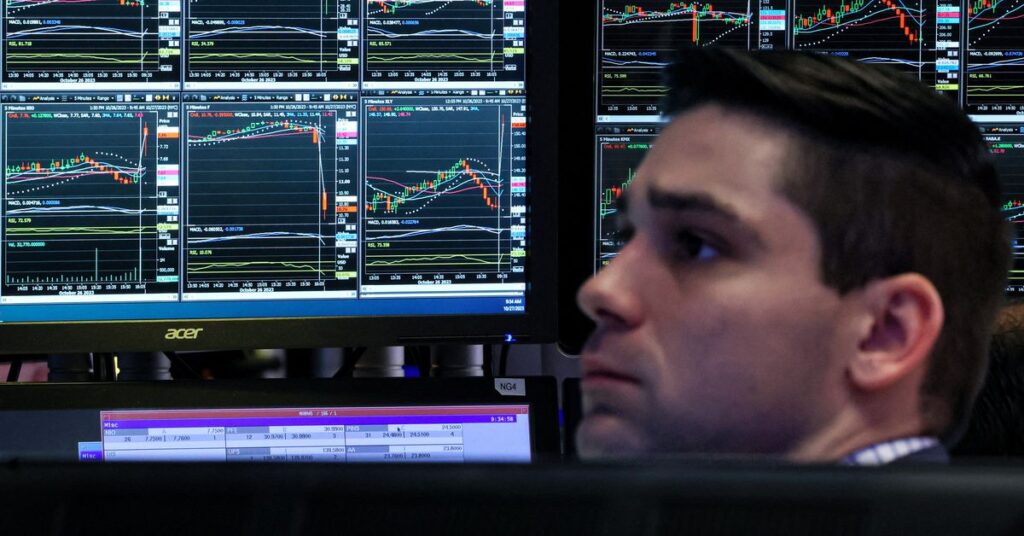 Traders work on the floor of the NYSE in New York
