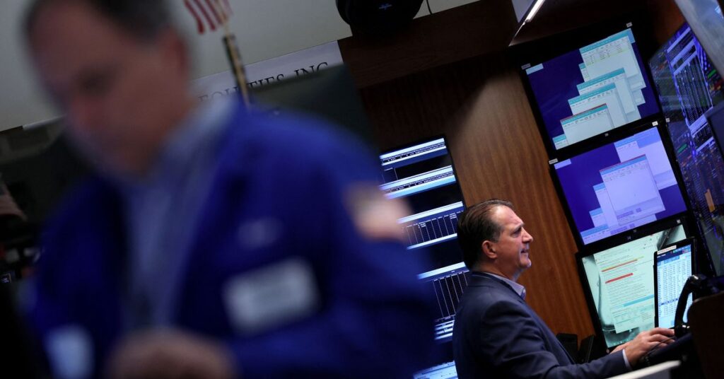 Traders work on the floor of the NYSE in New York