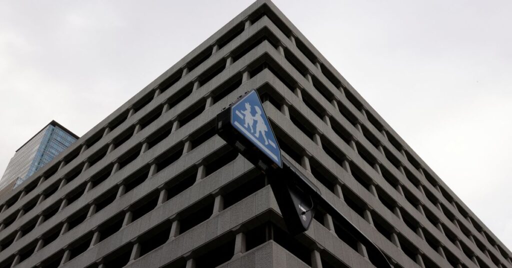 A traffic sign is seen in front of the headquarters of Bank of Japan in Tokyo
