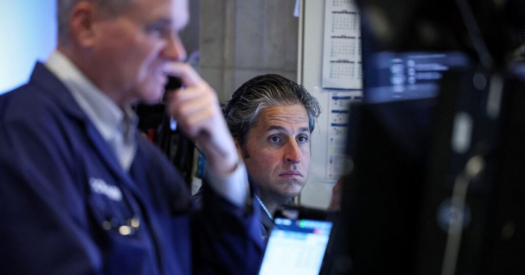 Traders work on the floor of the NYSE in New York
