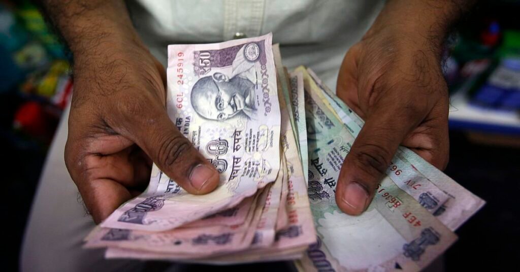 A private money trader counts Indian Rupee currency notes at a shop in Mumbai