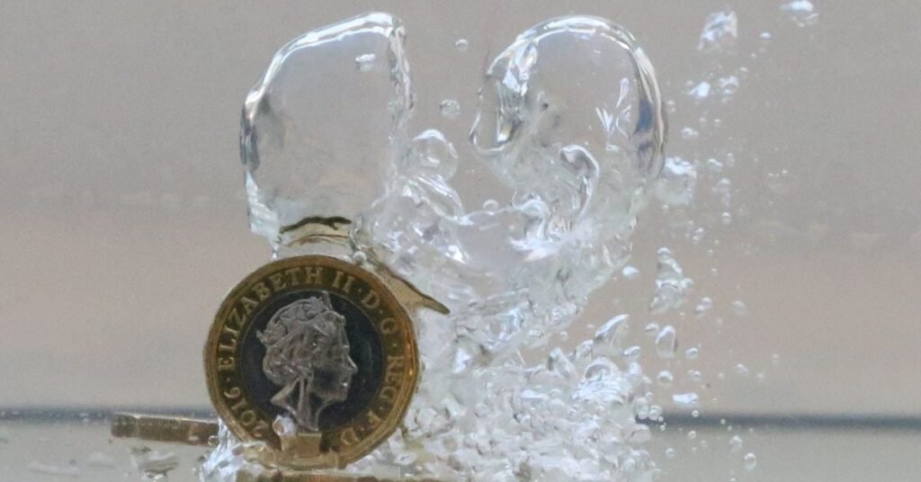 UK pound coins plunge into water in this illustration picture