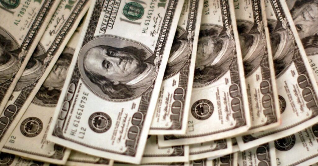 Four thousand U.S. dollars are counted out by a banker at a bank in Westminster