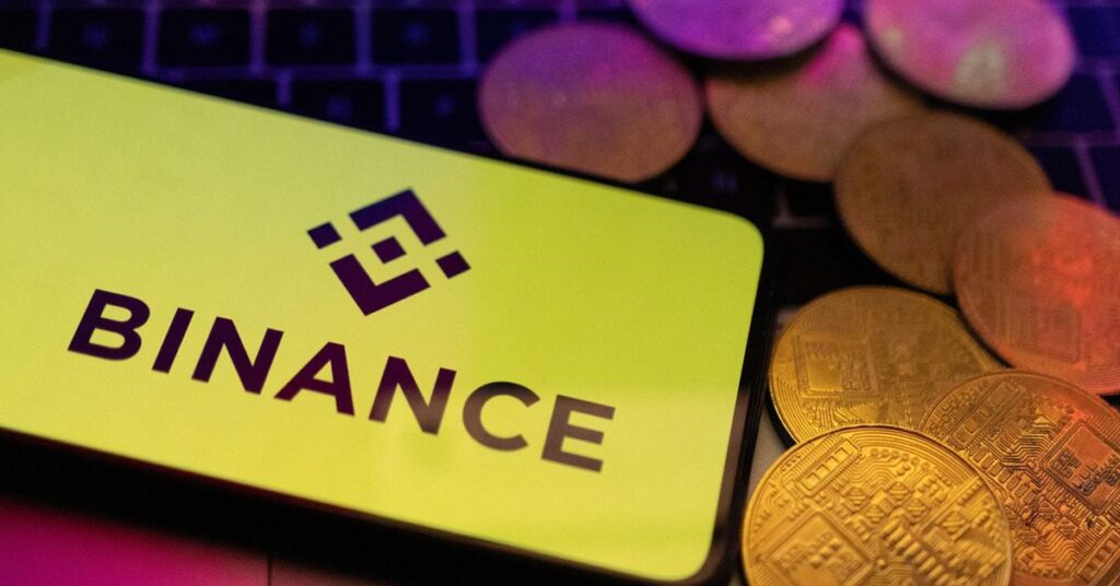 Illustration shows smartphone with displayed Binance logo