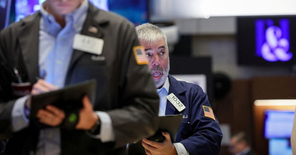 Traders work on the floor of the NYSE in New York