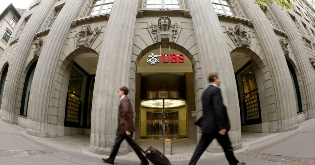 People walk past the headquarters of Swiss bank UBS in Zurich