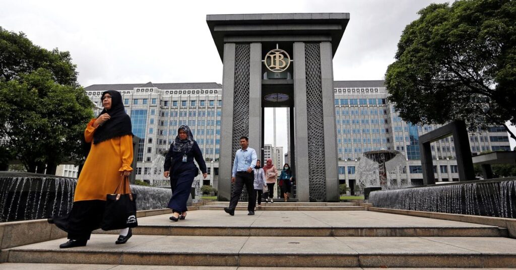 Visitors walk as they leave Bank Indonesia headquarters in Jakarta