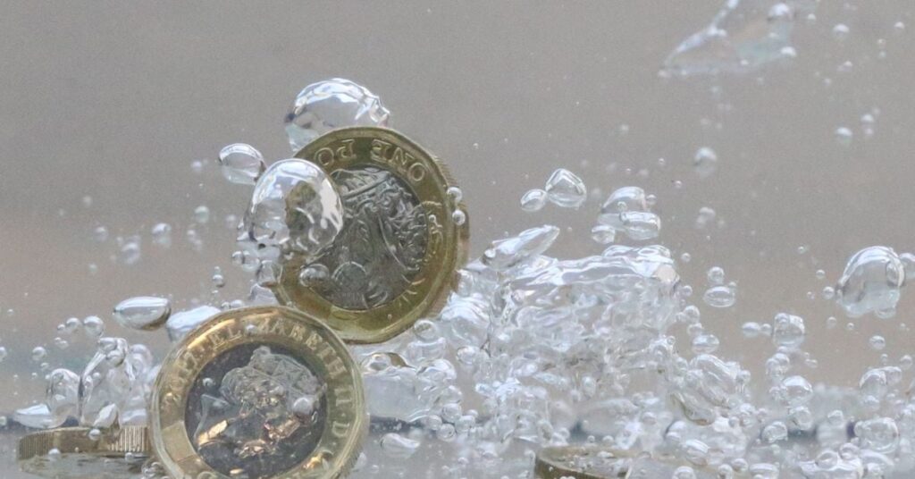 UK pound coins plunge into water in this illustration picture