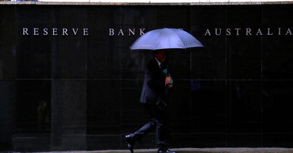 Pedestrians walk past the Reserve Bank of Australia building in central Sydney, Australia