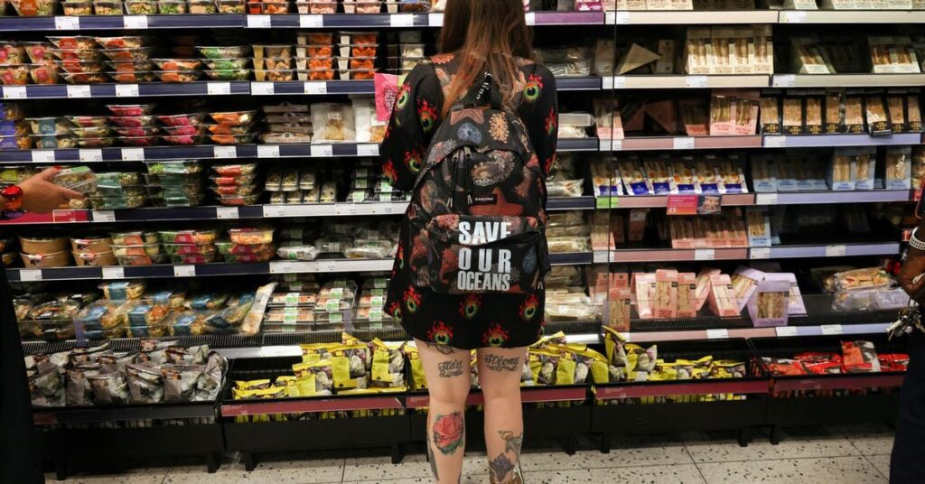 A person looks at food goods in a shop in London