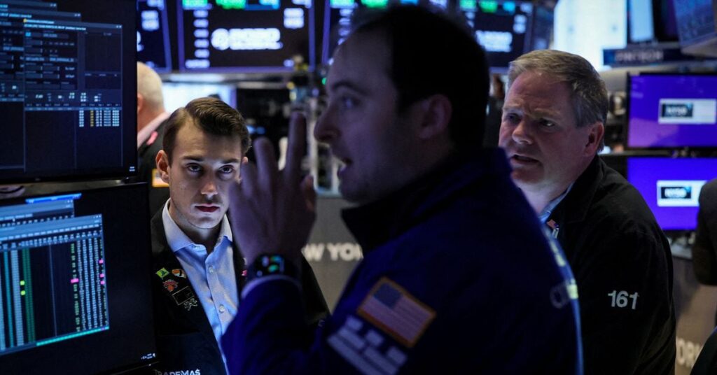 Traders work on the floor of the NYSE in New York
