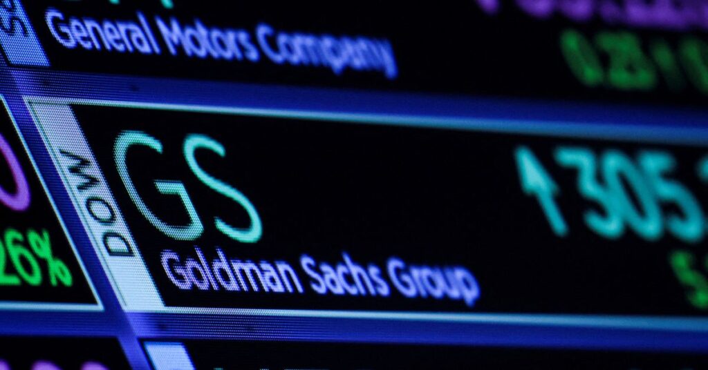 A screen displays the trading information for Goldman Sachs on the floor of the NYSE in New York